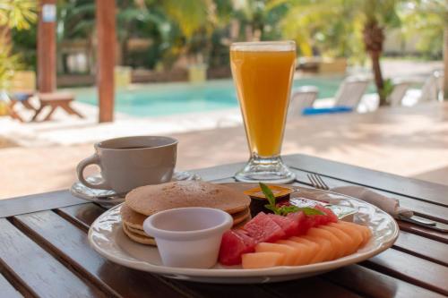 a plate of food and a drink on a table at TecnoHotel Valladolid in Valladolid