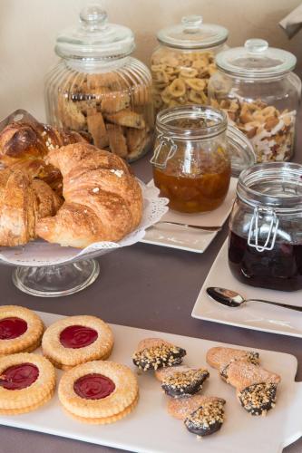 a table with various pastries and jars of jam at Borgo dé Brandi in Monteriggioni