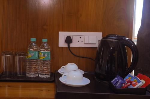 a counter with two bottles of water and a blender at Le Kumar Residency in Pondicherry