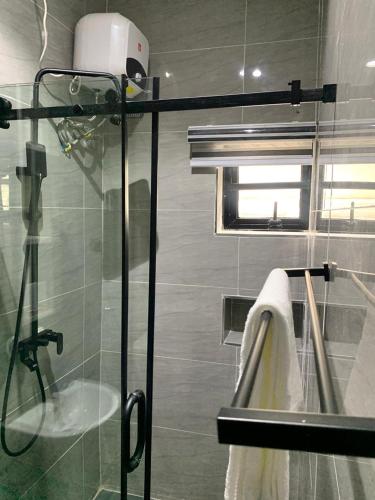 a bathroom with a shower with a glass door at Ehi-Mega Luxury Hotel and Apartment in Abuja