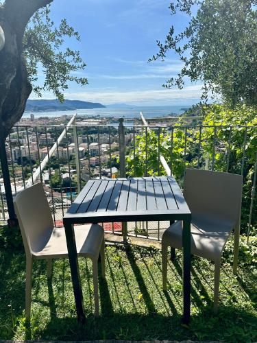 a table and two chairs sitting on top of a hill at 88 Miglia in La Spezia