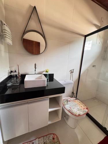 a bathroom with a sink and a toilet at Chalé Beijinho in Venda Nova do Imigrante