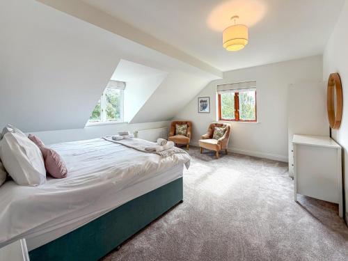 a bedroom with a large bed and a chair at 4 Bed in Tenby oc-vv27177 in Manorbier
