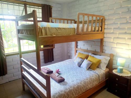 a bedroom with two bunk beds with pillows at Relax Home in Puyo