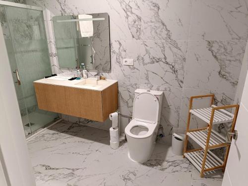 a bathroom with a sink and a toilet and a mirror at Sylvia Apartman in La Mata