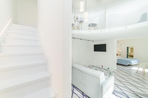 a room with white stairs and a living room at Palazzo Colavolpe in Atrani
