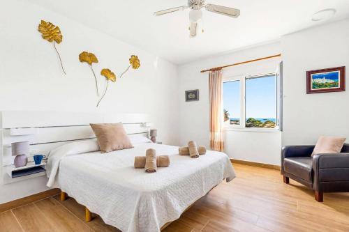 a bedroom with a bed with two teddy bears on it at Villa Adelaide by Villa Plus in Sant Lluis