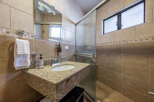 a bathroom with a sink and a mirror at Villa Sol 23 in Playa Hermosa