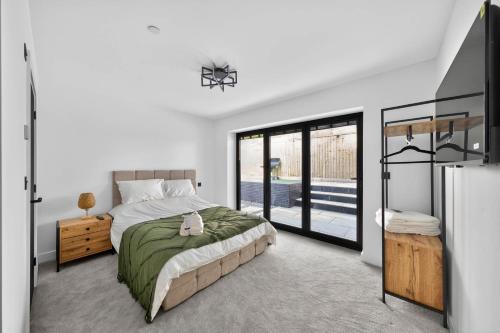a bedroom with a bed and a sliding glass door at Heddfan in Carmarthen