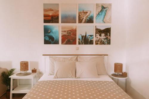 a bedroom with a bed and some pictures on the wall at Studio Mare in Zadar