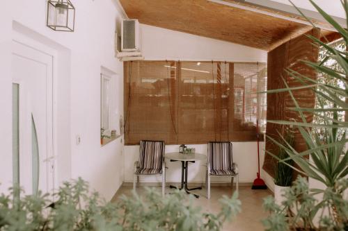a dining room with two chairs and a table at Studio Mare in Zadar