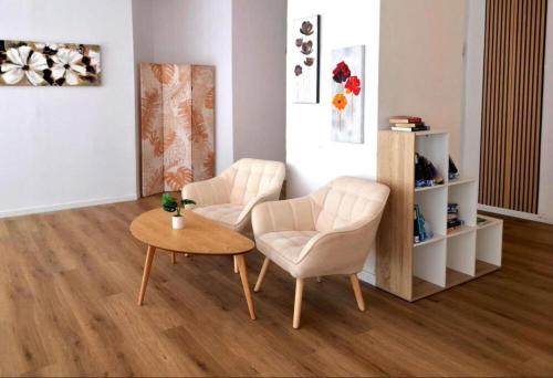 a living room with two chairs and a table at BLUESEA Torremolinos Centro in Torremolinos