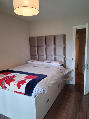 a bedroom with a large bed with a large headboard at Bedroom in Blanchardstown in Blanchardstown