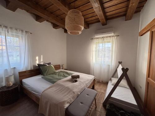 a bedroom with a bed and a chair in it at Erdő mellett lebzselő in Mogyoróska