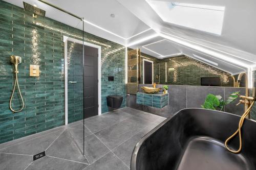 a bathroom with a sink and a glass shower at Ty Hir in Llanelli