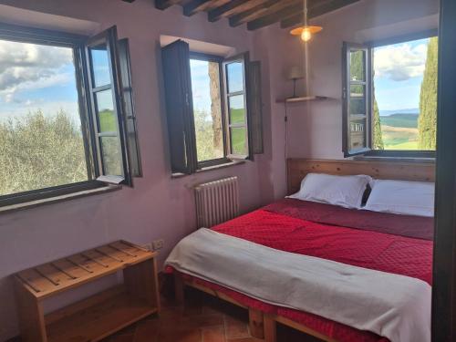 a bedroom with two beds and two windows at Garbo Home in Asciano