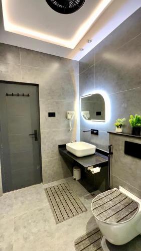 a bathroom with a toilet and a sink at Luxury Private Room Canal Rd Near Galleria in Faisalabad