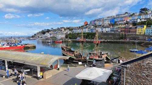 a group of boats docked in a harbor with buildings at One Fisherman's Loft in Brixham