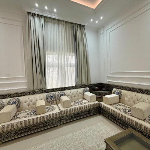 a living room with a couch and a window at منزل الوادي in Fujairah