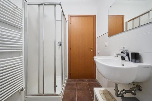 a bathroom with a sink and a glass shower at Casa La Polledraia in Venturina Terme