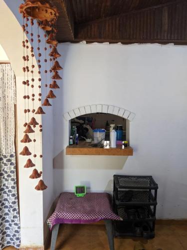 a kitchen with a table and a counter with a shelf at dankotuwa in Seeduwa