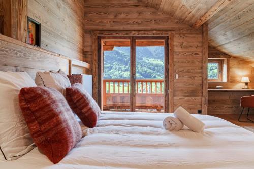 a bedroom with a large bed in a wooden cabin at chalet in authentic Manigod farm in Manigod