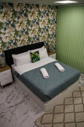 a bed with two pillows on it in a bedroom at Sylvia Apartman in La Mata