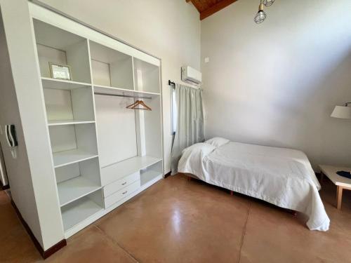 a bedroom with a bed and a large closet at Monoambiente PIPE in Bella Vista