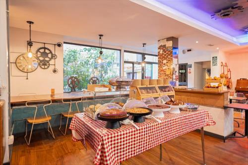 a kitchen with a table with food on it at Ostello Bello Roma Colosseo in Rome