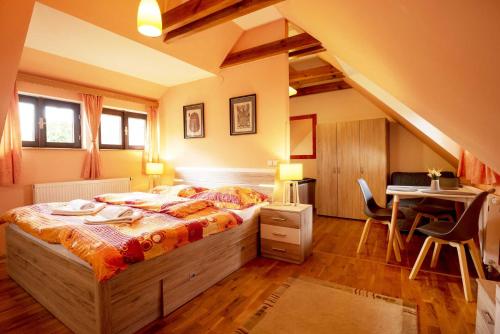 a bedroom with a bed and a desk and a table at Apartmány v Centru in Třeboň
