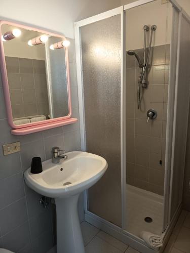 a bathroom with a sink and a shower with a mirror at Albergo Bellavista in Re