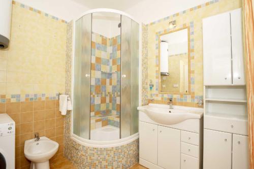 a bathroom with a sink and a shower and a toilet at Apartmány v Centru in Třeboň