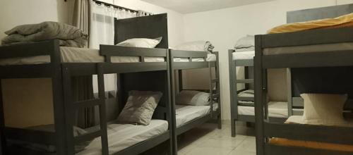 a group of bunk beds in a room at Canaan Hôtel Antsirabe in Antsirabe