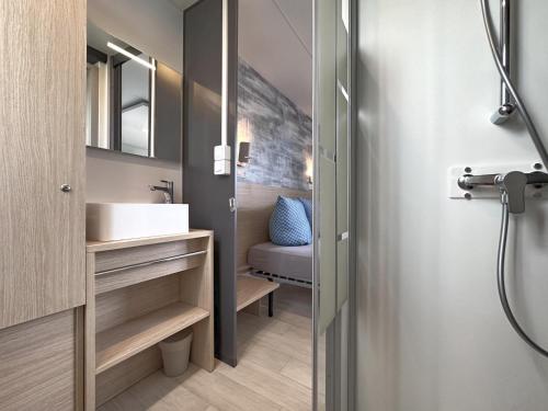 a bathroom with a sink and a mirror at Feriendorf Seeblick - Tiny Nr 11 in Neunburg vorm Wald