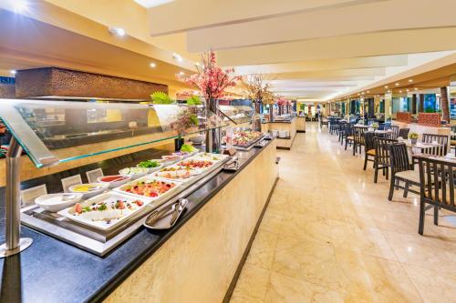 a buffet line with many plates of food at The Sens Cancun by Oasis - All Inclusive in Cancún
