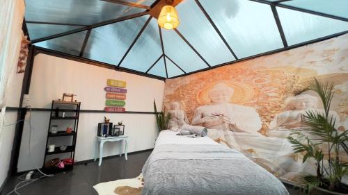 a bedroom with a large painting on the wall at Harmony Deluxe Accommodation in Água de Pau
