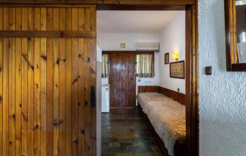 a room with a bed and a wooden door at GM View Oropos in Oropos