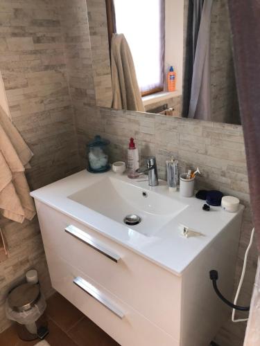 a bathroom with a white sink and a mirror at La calade in Roquefort-les-Pins