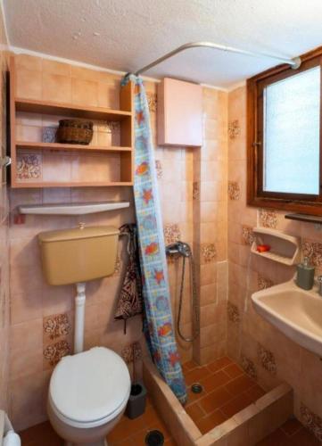 a small bathroom with a toilet and a sink at GM View Oropos in Oropos