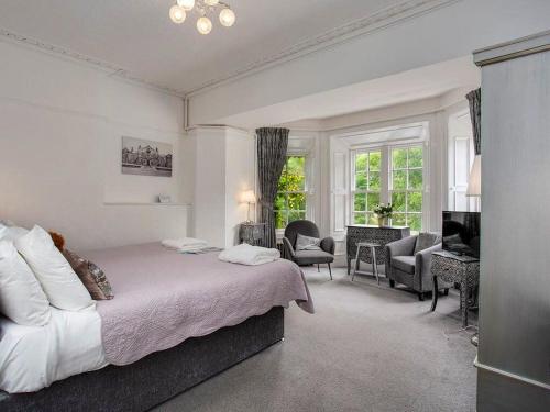a bedroom with a bed and a living room at Atholl Arms in Blair Atholl