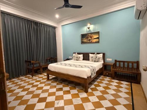 a bedroom with a bed with a checkered floor at Vista villa in Pushkar
