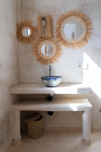 a bathroom with a sink and mirrors on the wall at Villa Luxury Spacious Moroccan ,Private Pool in Essaouira