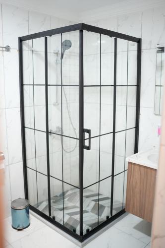 a shower with a glass door in a bathroom at Burgaz Resort Aquapark Hotel in Kırklareli