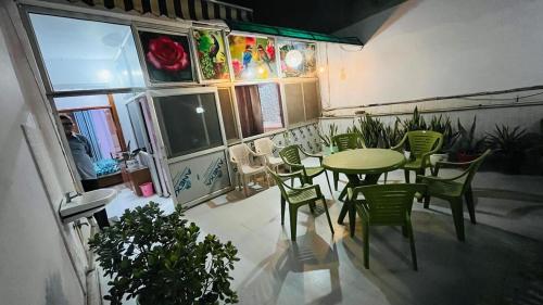 a dining room with a table and chairs in a room at Marble Man Homestay in Agra
