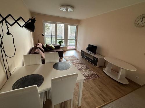 a living room with a white table and chairs at Vabaduse tn 72 in Narva-Jõesuu