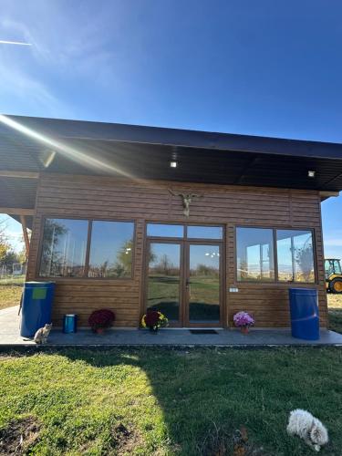 a small house with a large window at Șoaptele Naturii A-frame in Buzău