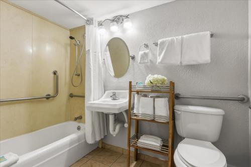 a bathroom with a toilet and a sink and a tub at Nautilus Inn - Daytona Beach in Daytona Beach