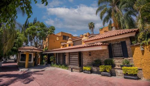 an old brick house with a tile roof at Hotel La Mansion del Sol in Guadalajara