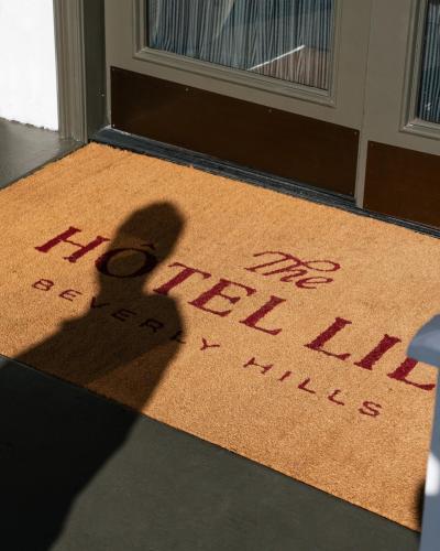 a shadow of a key on a rug in front of a door at The Hotel Lili in Los Angeles