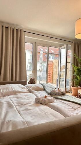 a large white bed with towels on top of it at AMAO-Sienna - Walk to Europa-Park - Terrace - 6 Guests in Rust
